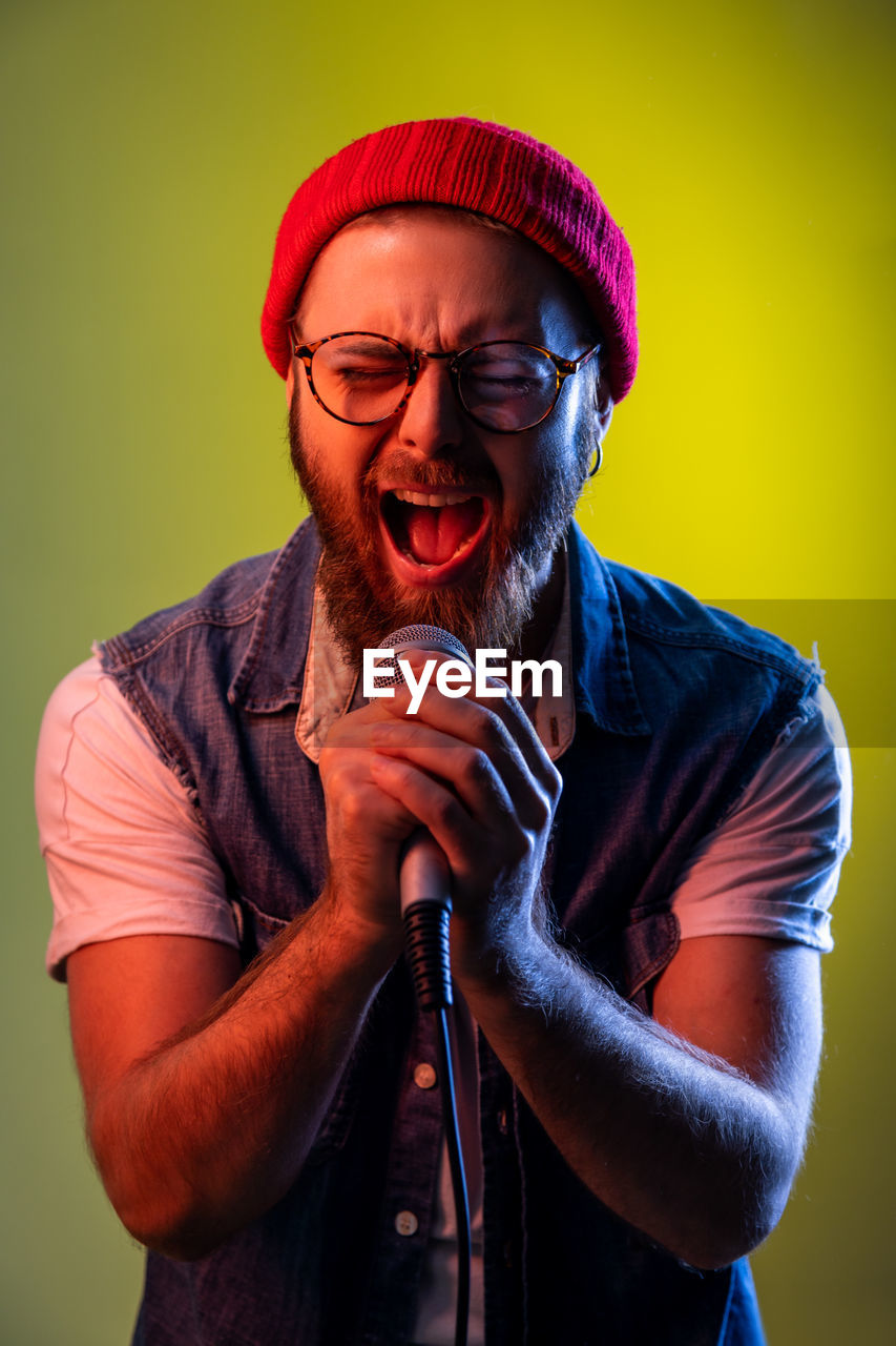 Man shouting while performing on mic