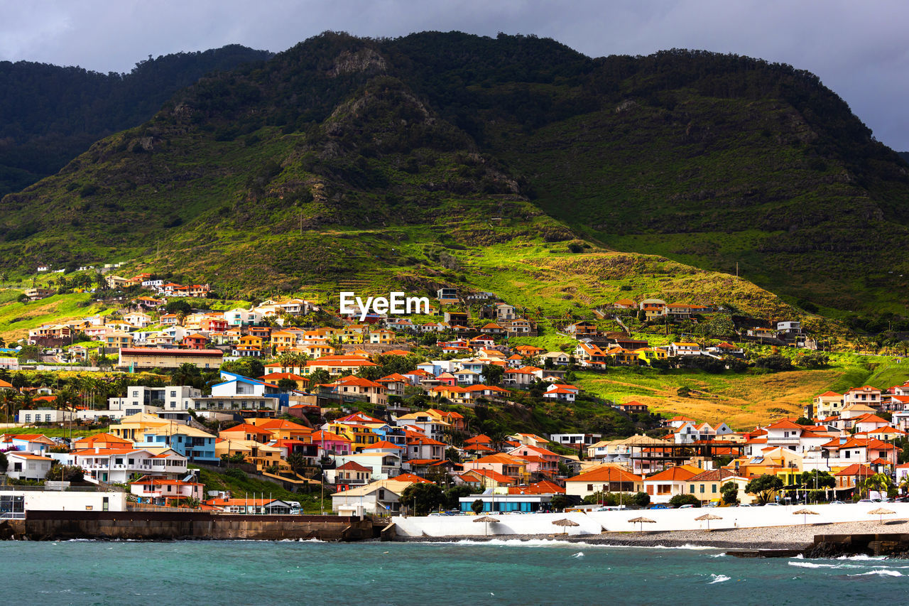 high angle view of townscape by mountain range