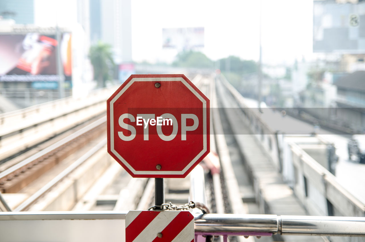 Close-up of road sign against city