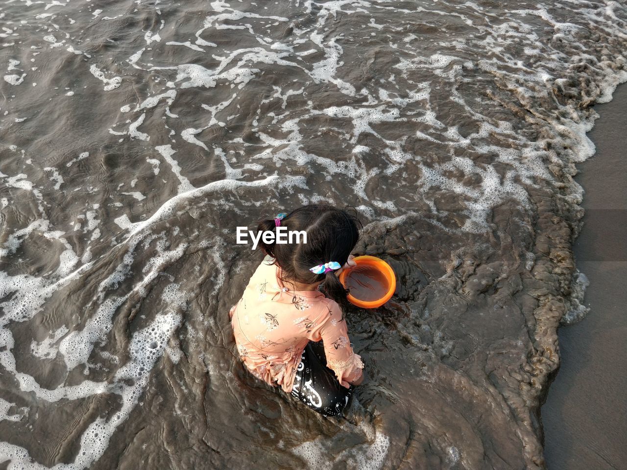 High angle portrait of girl playing in sea