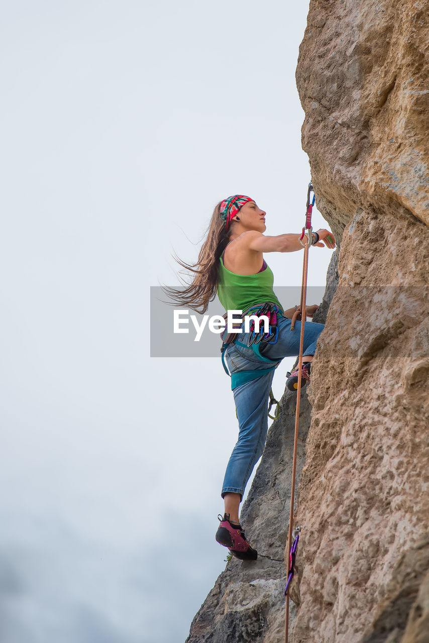 Low angle view of person standing on rock