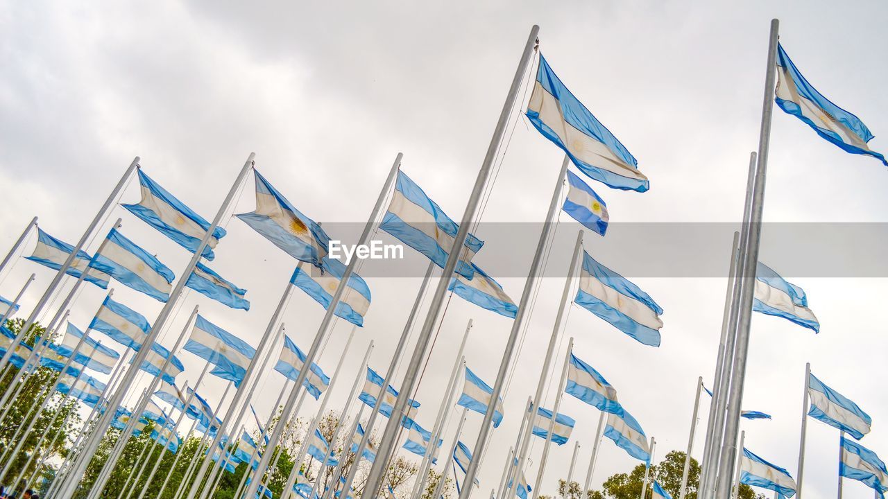 Low angle view of flags against sky