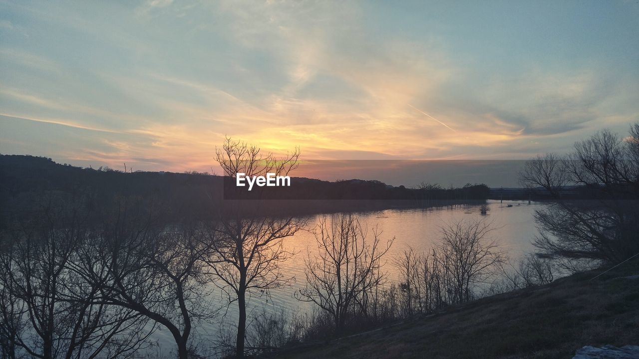 SCENIC VIEW OF LAKE AT SUNSET