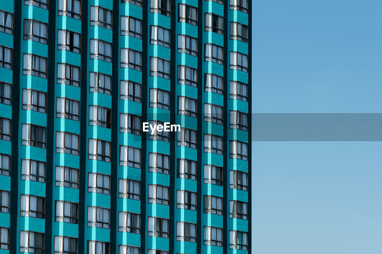 Turquoise skyscraper building windows texture