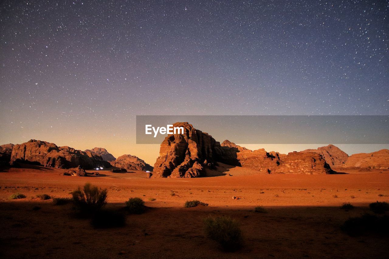 Scenic view of desert and mountains against sky