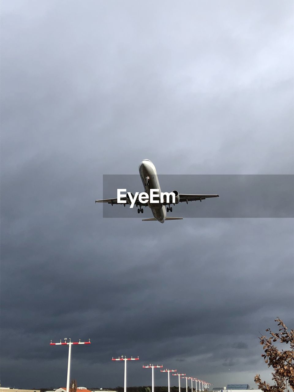 Low angle view of airplane flying against sky