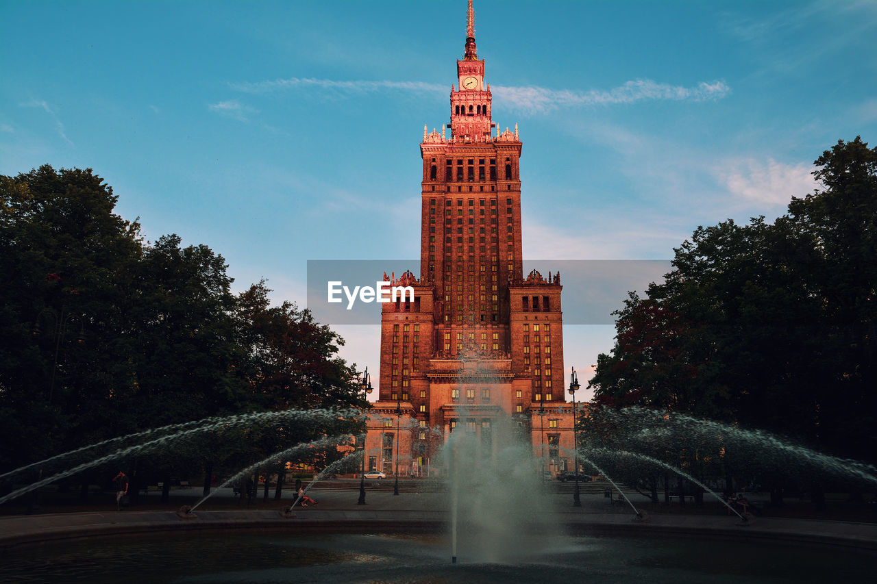 Fountain against building in city