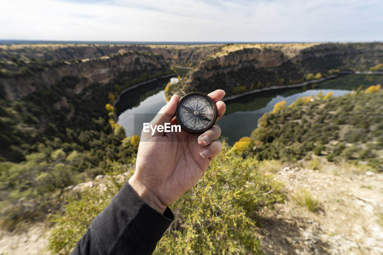 MAN HOLDING ROCK