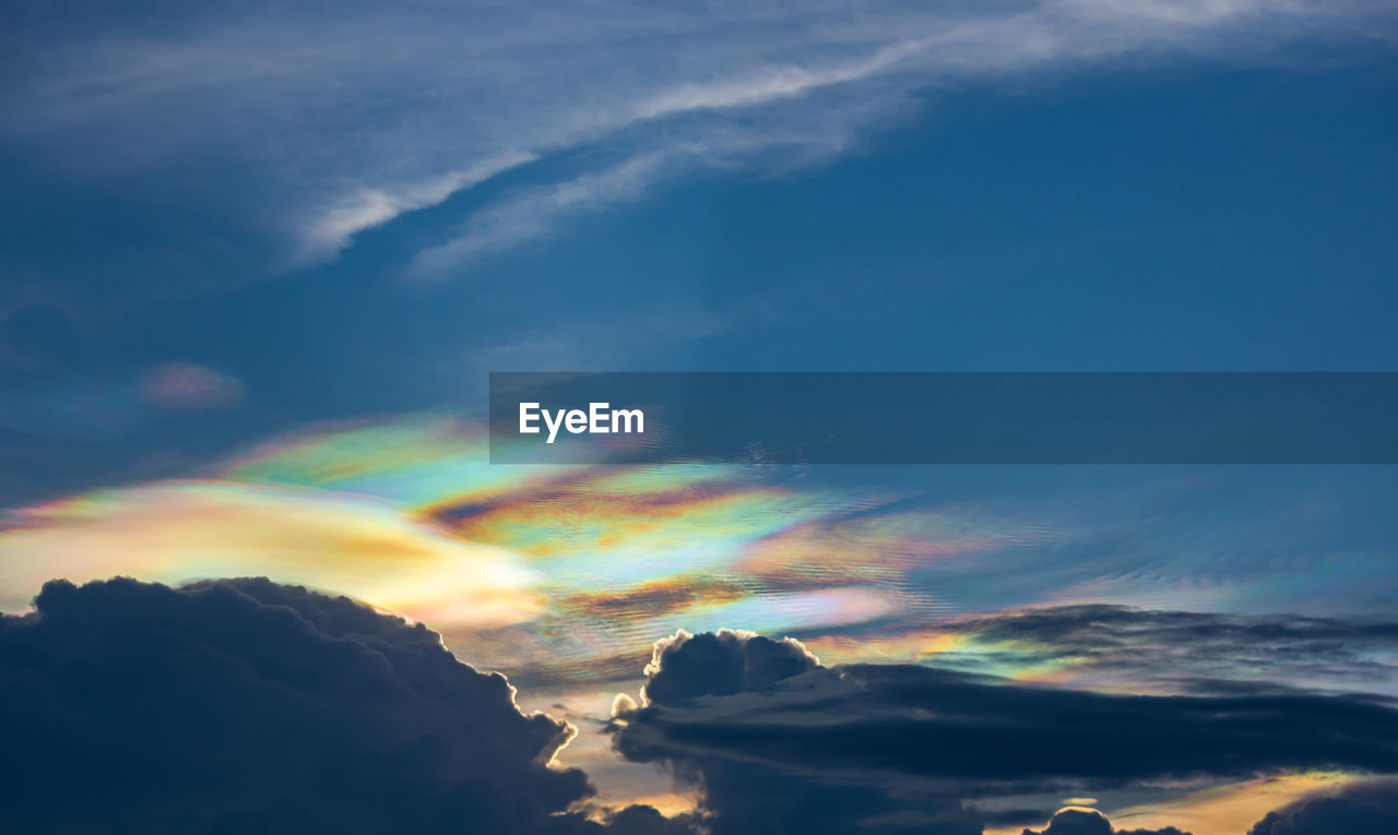 LOW ANGLE VIEW OF RAINBOW IN SKY