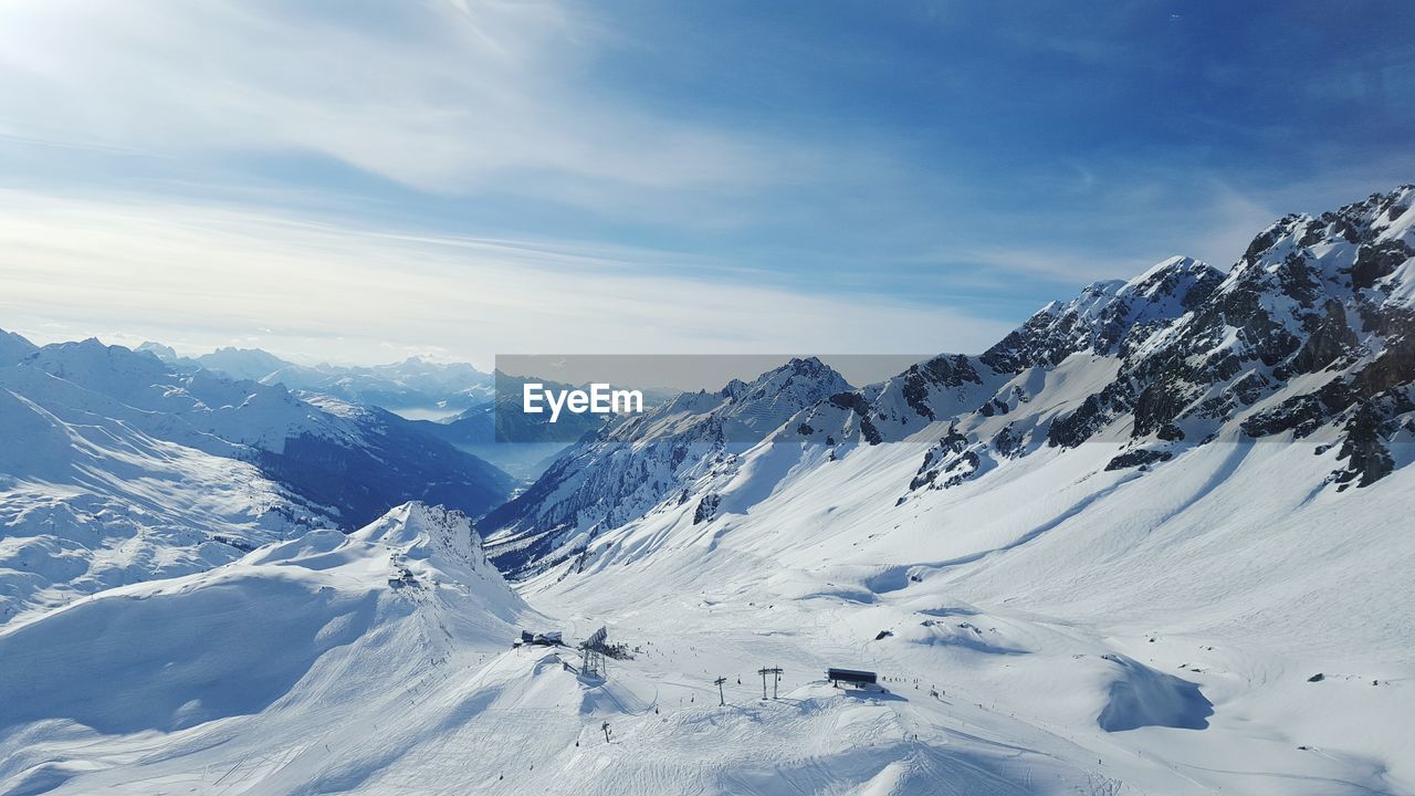 Scenic view of snow covered mountains against sky