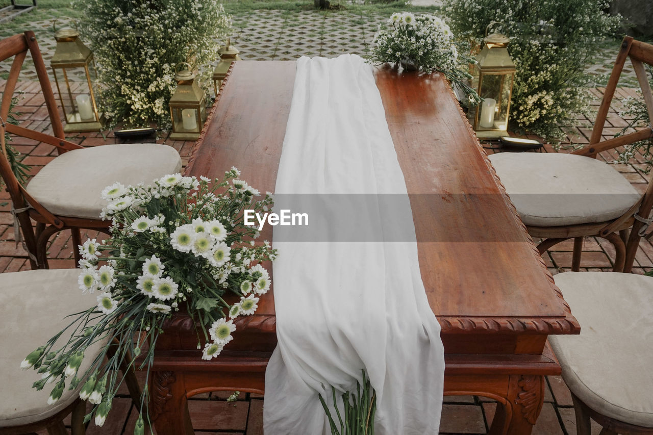 High angle view of flower arrangement on table at cafe