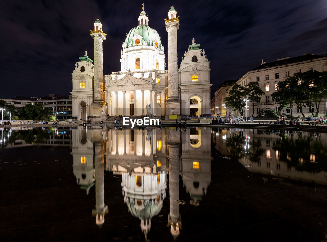 REFLECTION OF ILLUMINATED BUILDINGS IN CITY AT NIGHT