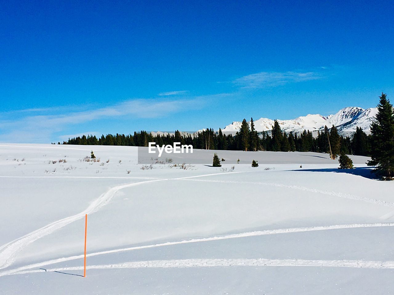 SNOW COVERED MOUNTAINS AGAINST BLUE SKY