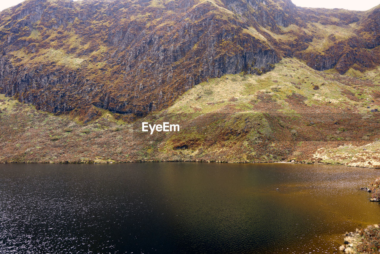 Scenic view of lake by mountain during autumn