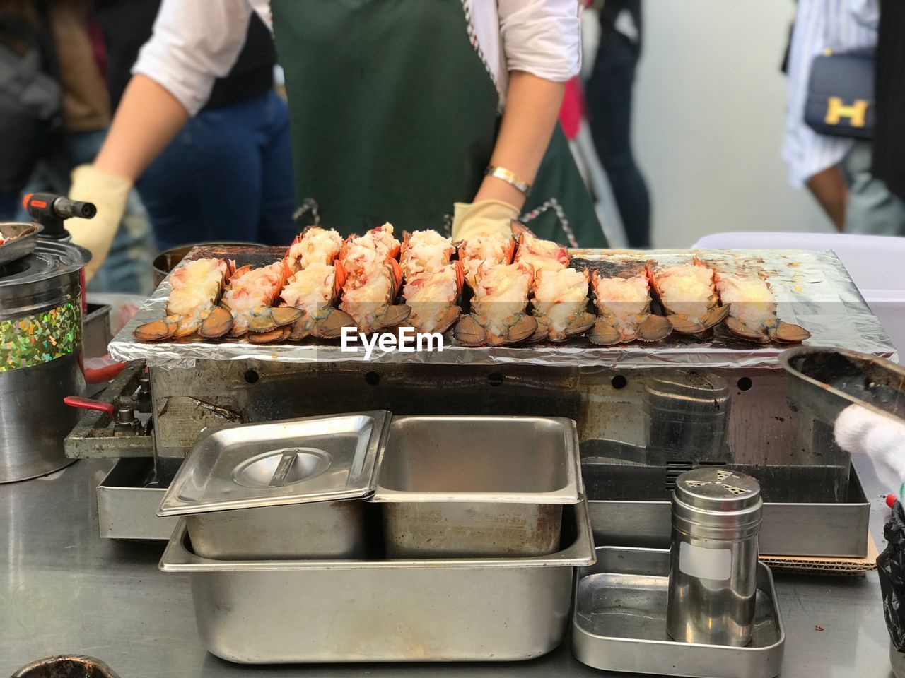 Midsection of chef preparing food in commercial kitchen