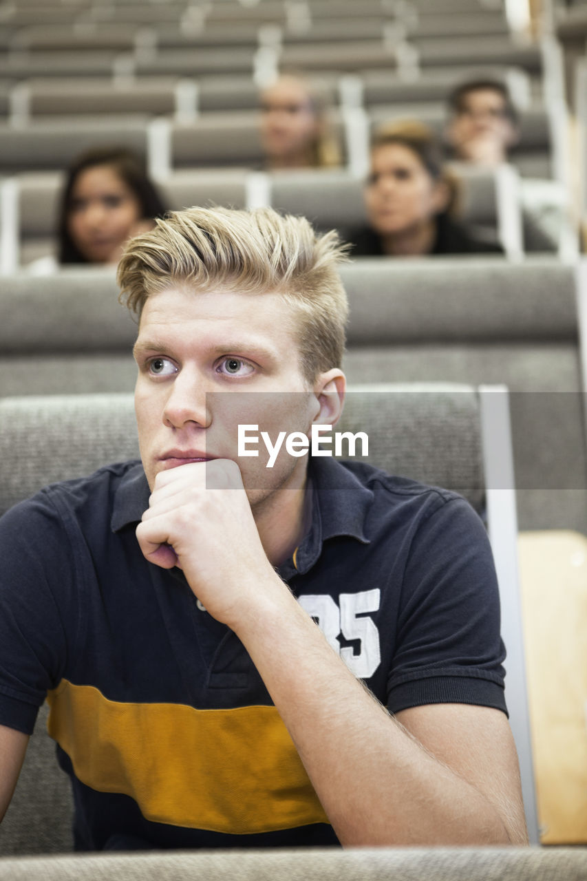 Close up of handsome young man concentrating on seminar