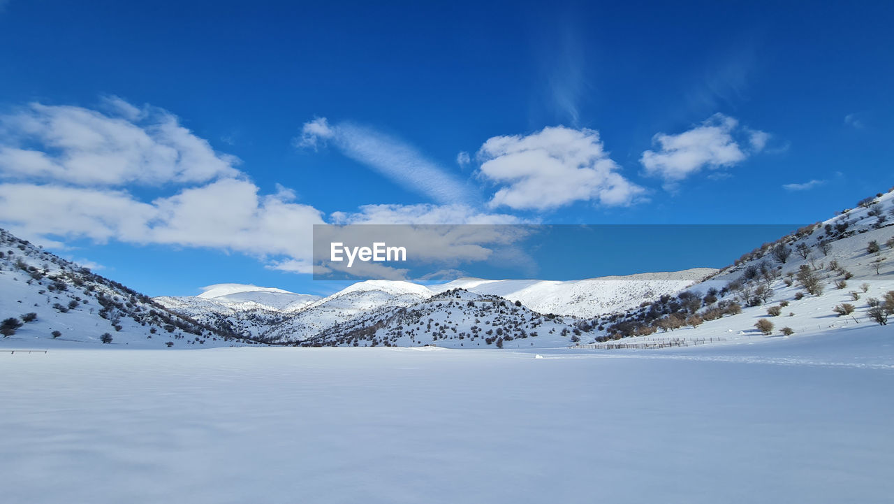 Scenic view of israeli hermon snowcapped mountain against sky during sunset. exotic winter.