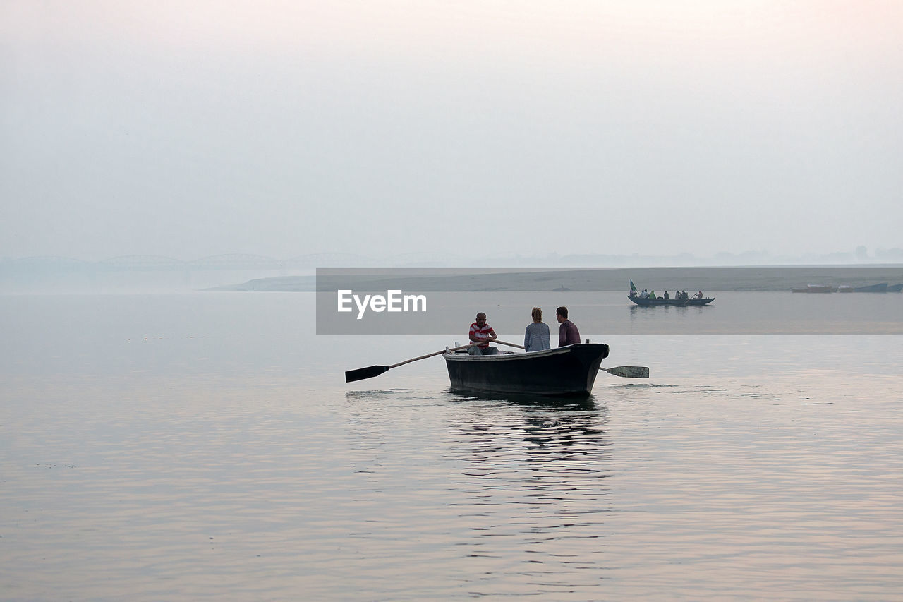 PEOPLE ON BOAT IN WATER