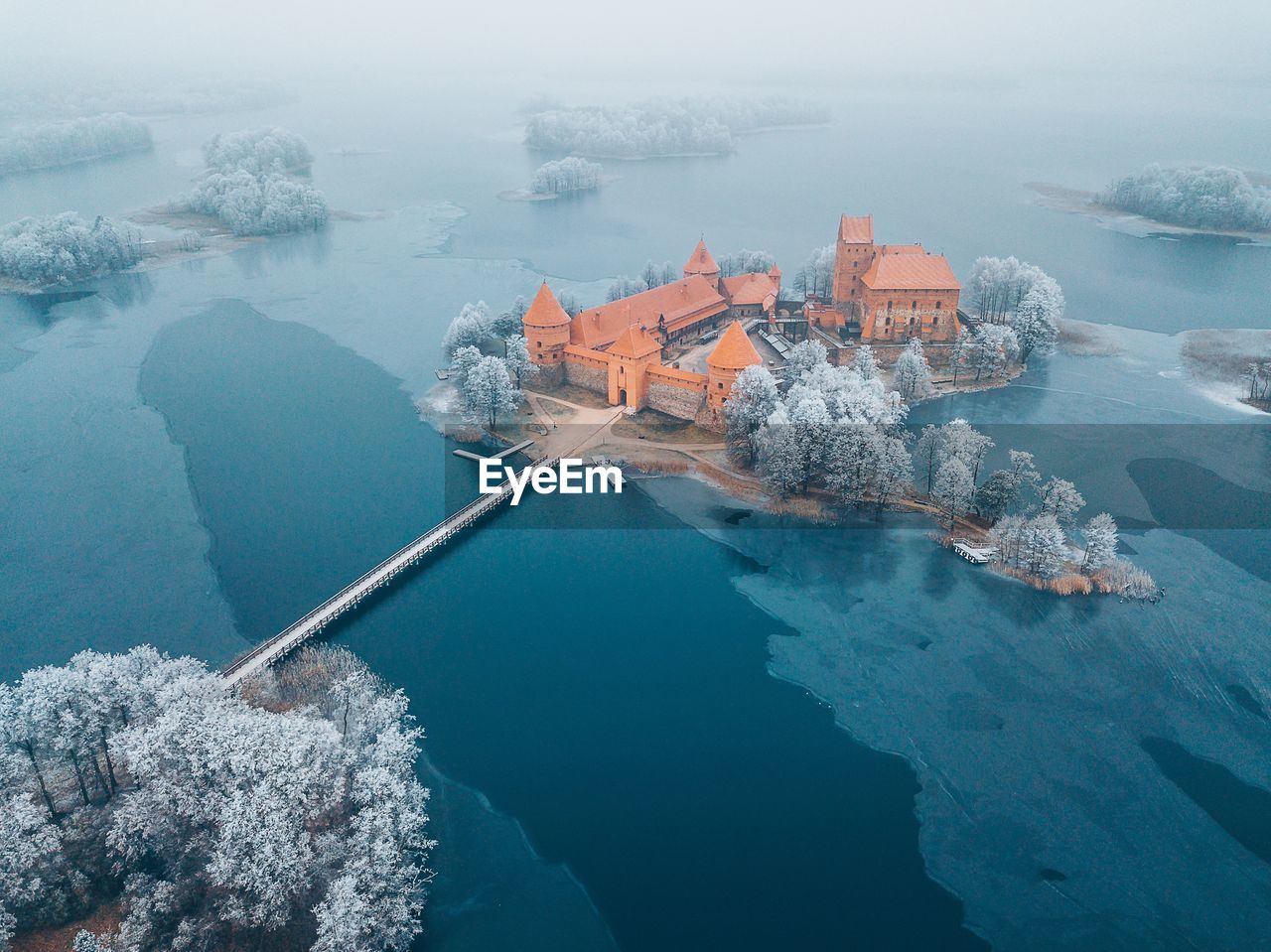 Aerial view of buildings amidst frozen lake