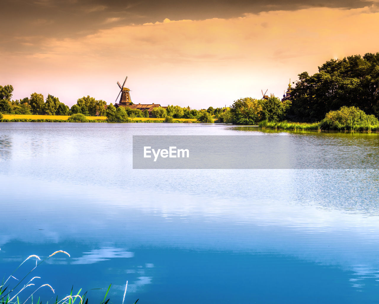 Scenic view of lake against sky during sunset