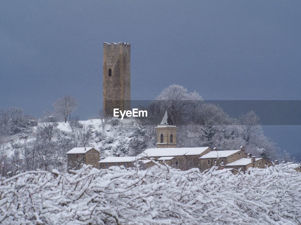 Medieval tower and town under the snow