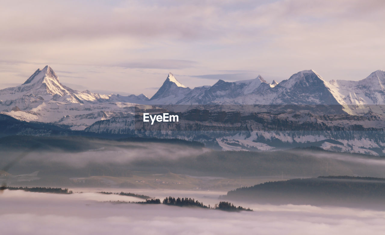 Scenic view of snowcapped mountains against sky