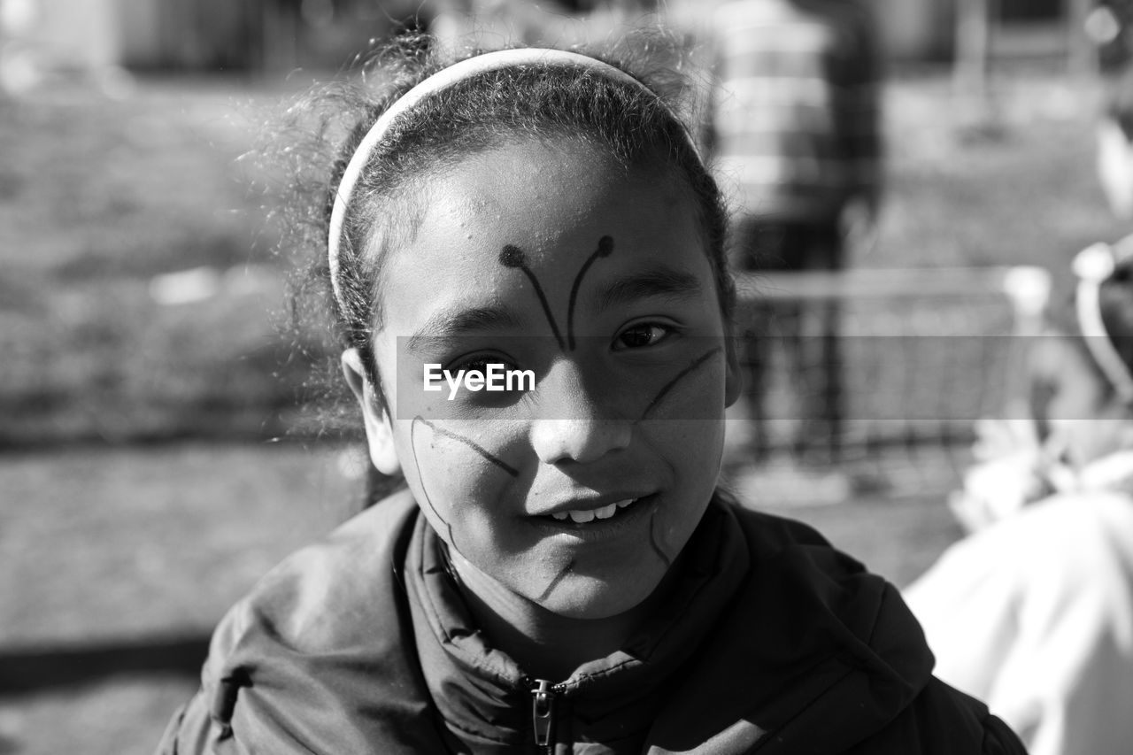 Close-up portrait of girl with painted face