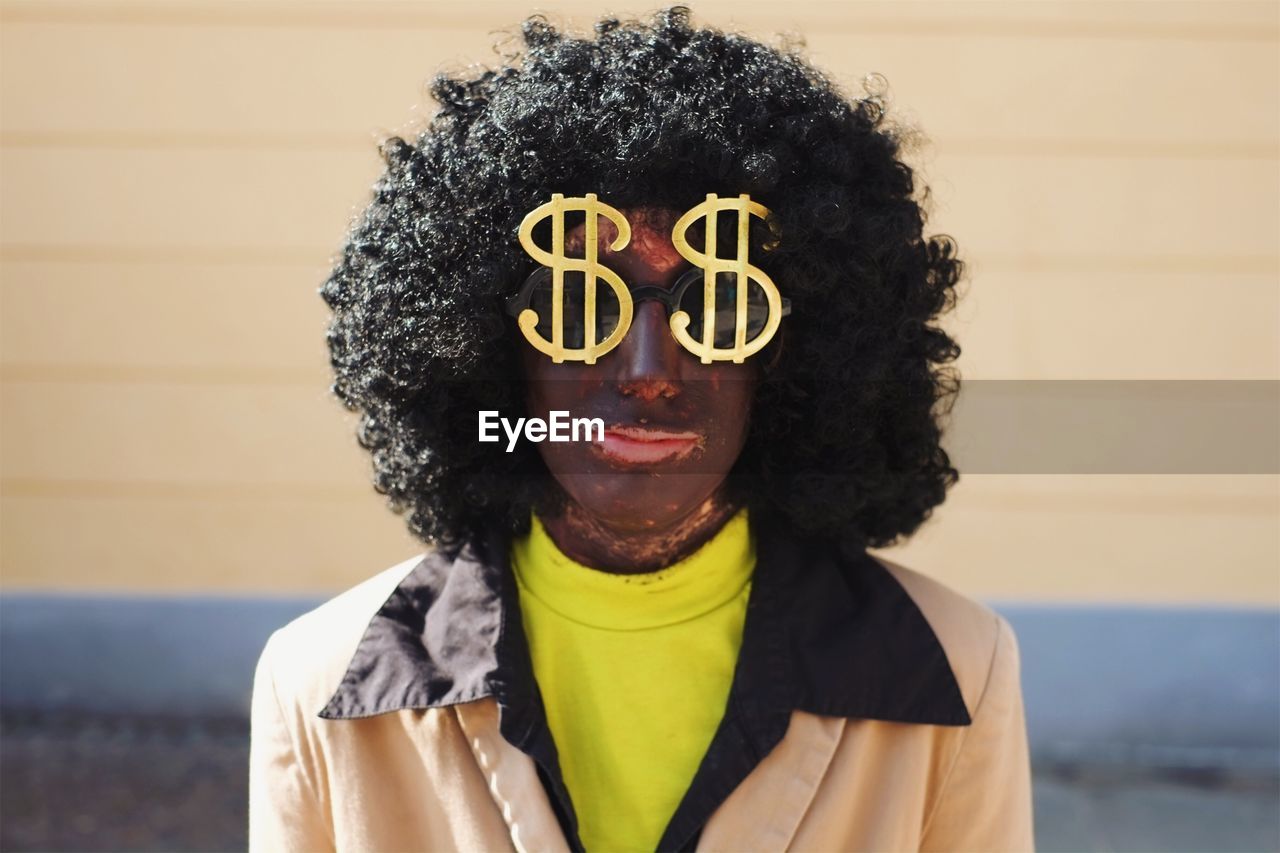 Portrait of woman wearing sunglasses with dollar sign