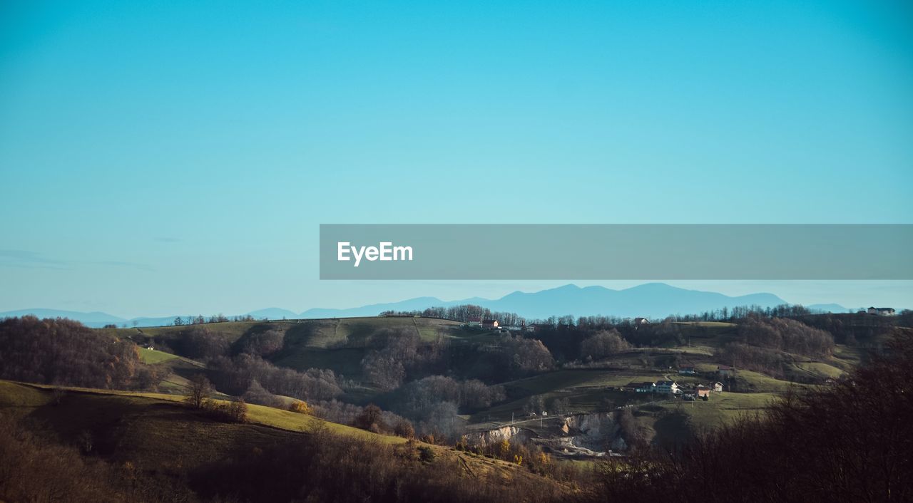 SCENIC VIEW OF LANDSCAPE AGAINST BLUE SKY