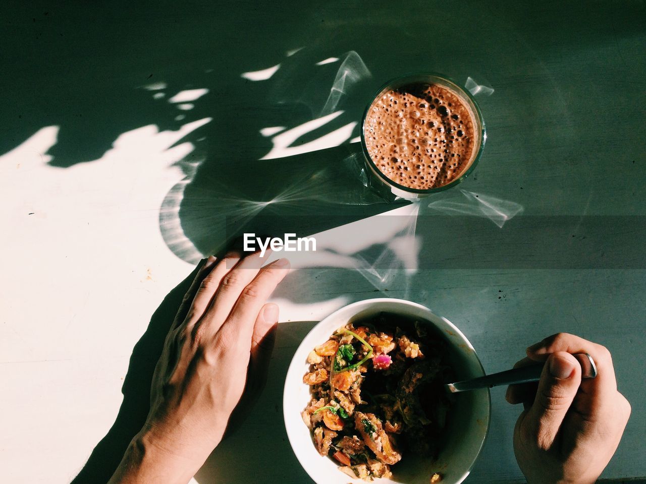 Close-up of hands eating food at table