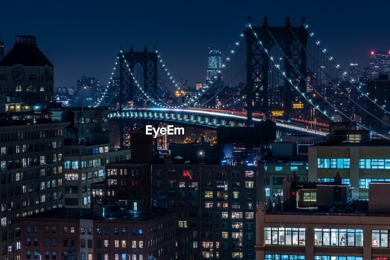 Illuminated cityscape against sky at night