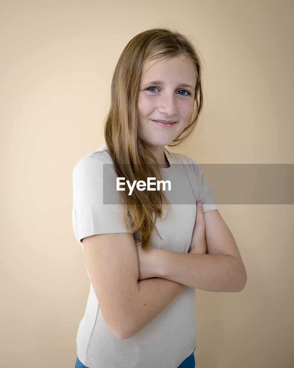 portrait of young woman standing against wall at home