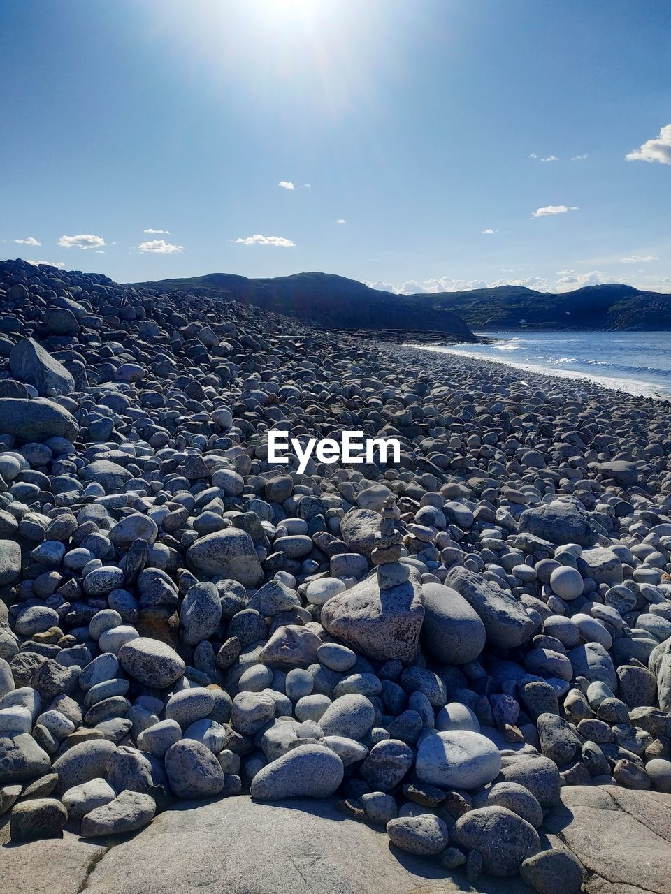 ROCKS IN SEA AGAINST SKY