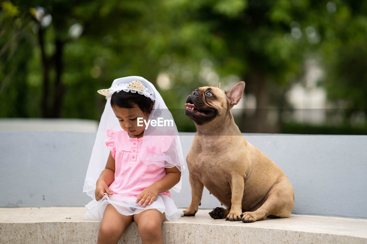 Cute girl sitting with dog