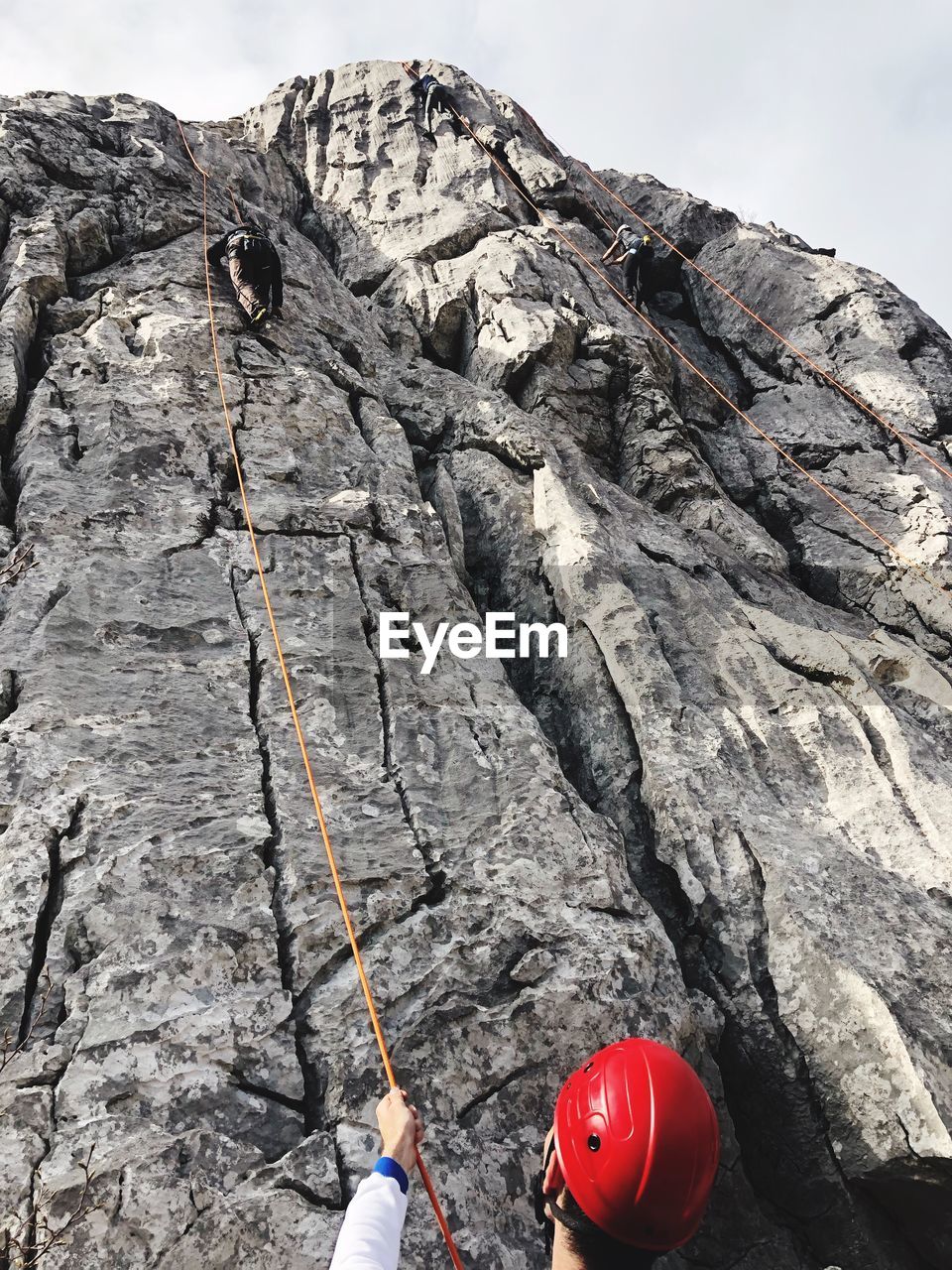 Rear view of man climbing on rocky mountain