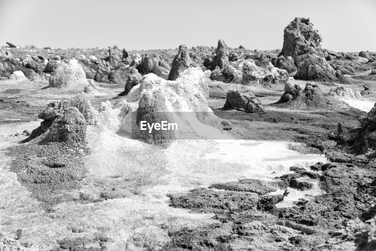 SCENIC VIEW OF ROCKS IN WATER AGAINST SKY