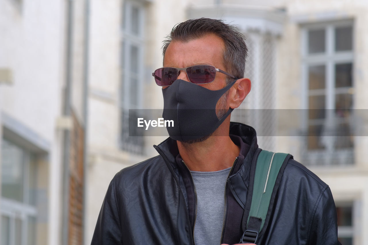 Portrait of man wearing sunglasses standing outdoors