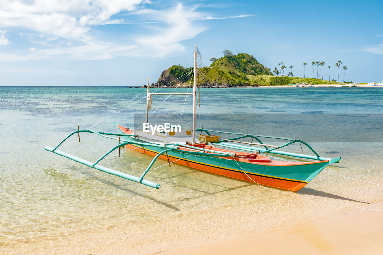 Boat on beach against sky