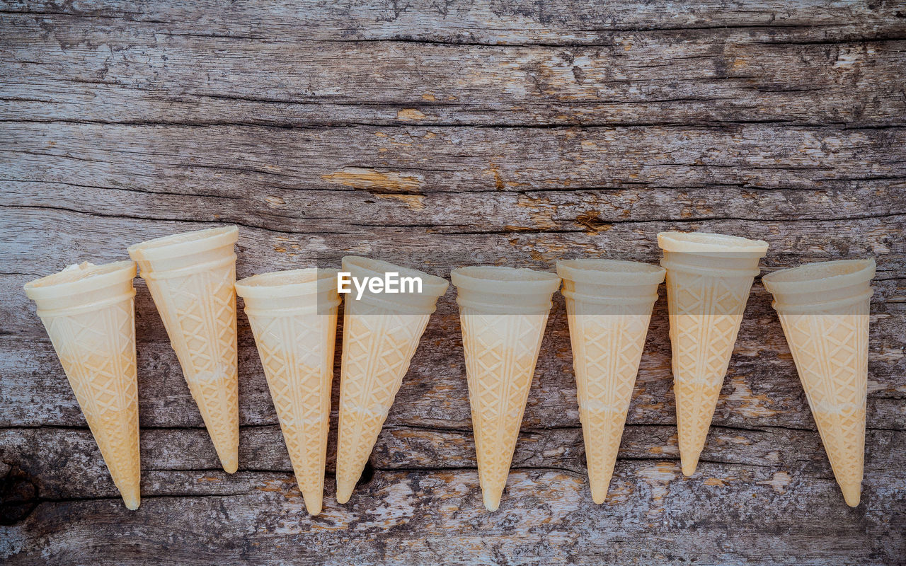 High angle view of ice cream cones on wooden table