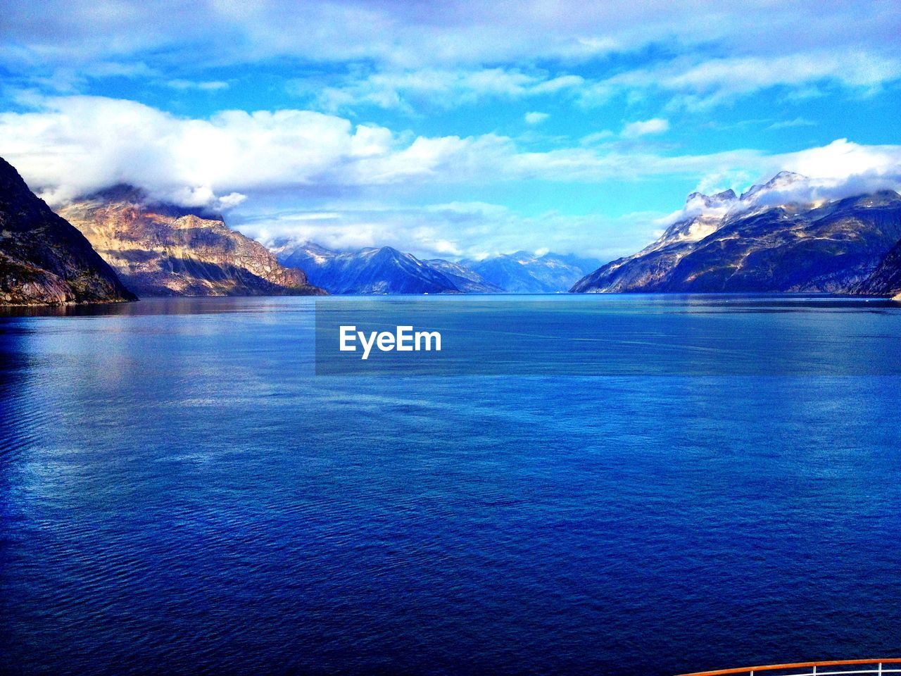 Scenic view of lake against cloudy sky