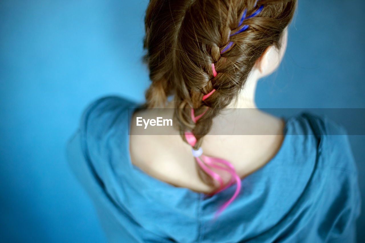 Generation z girl hairstyle on blue background. colorful hair