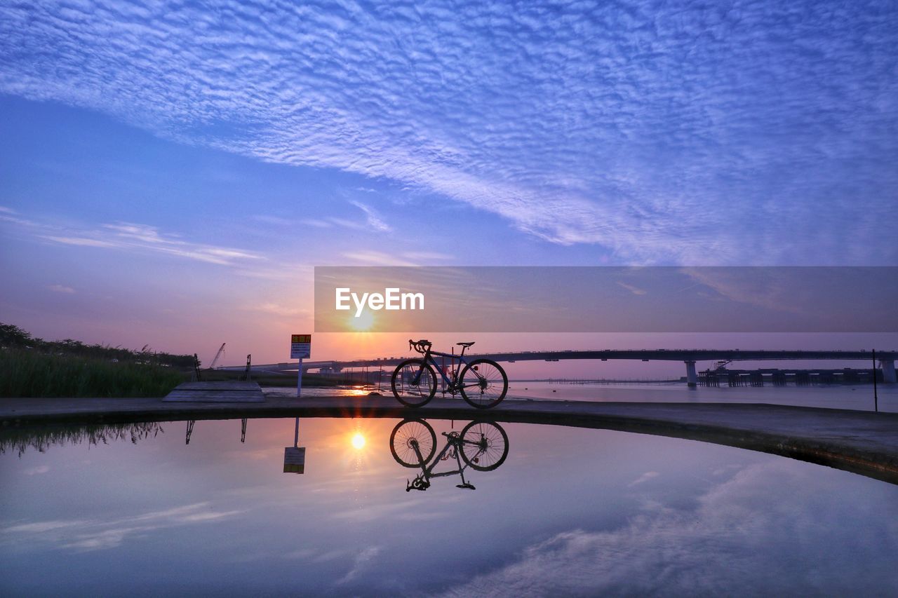 View of bridge over lake against sky during sunset