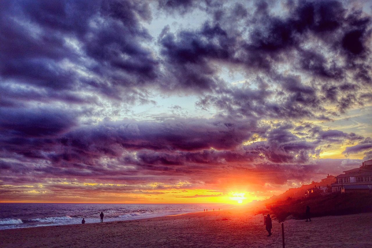 Scenic view of cloudy sky over beach during sunset