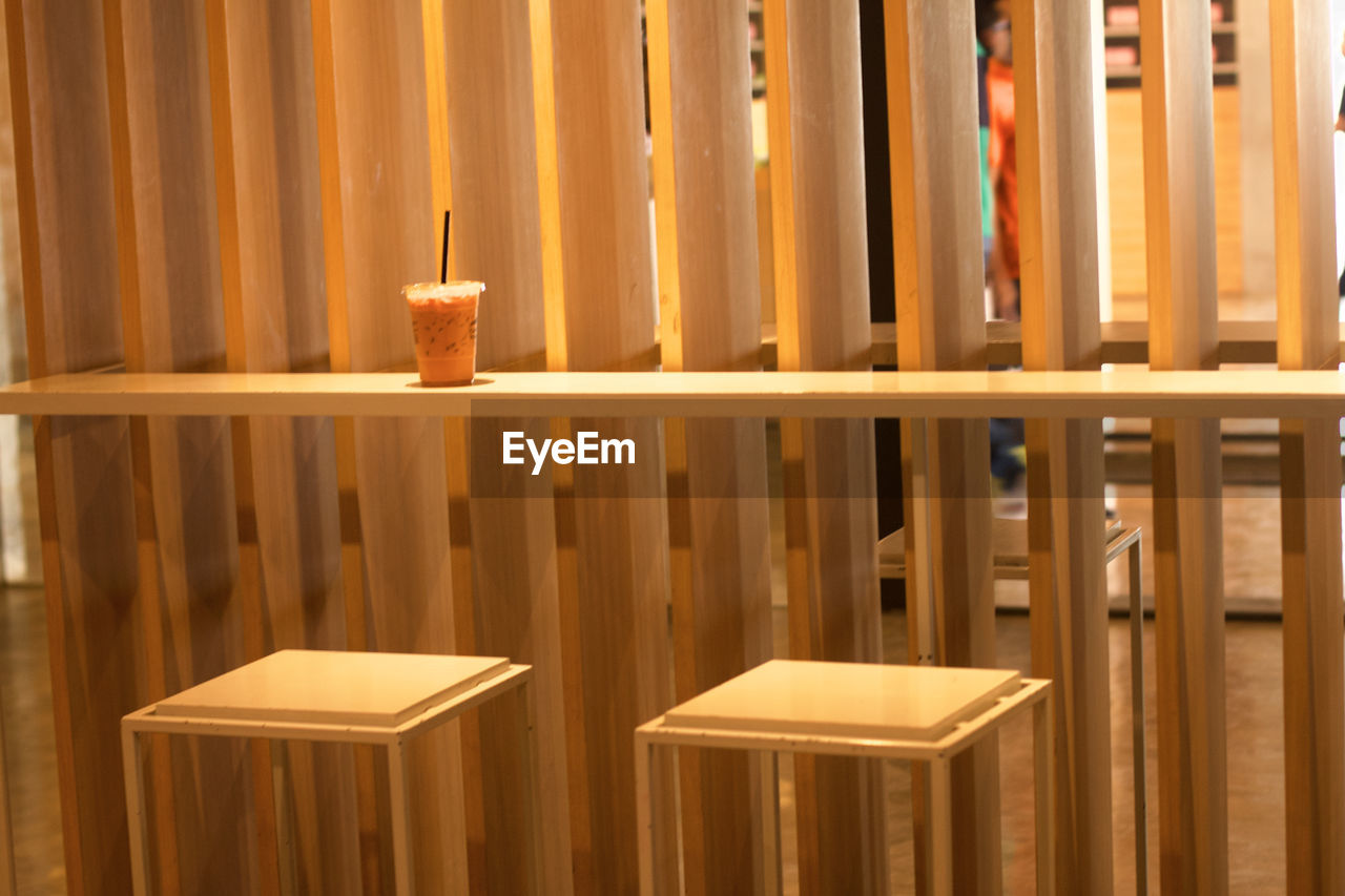 Close-up of candles on table against wall