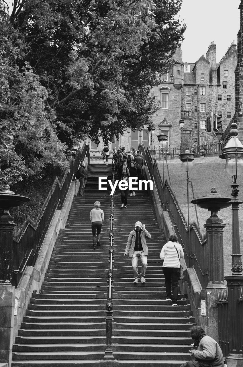 HIGH ANGLE VIEW OF PEOPLE WALKING ON STAIRS