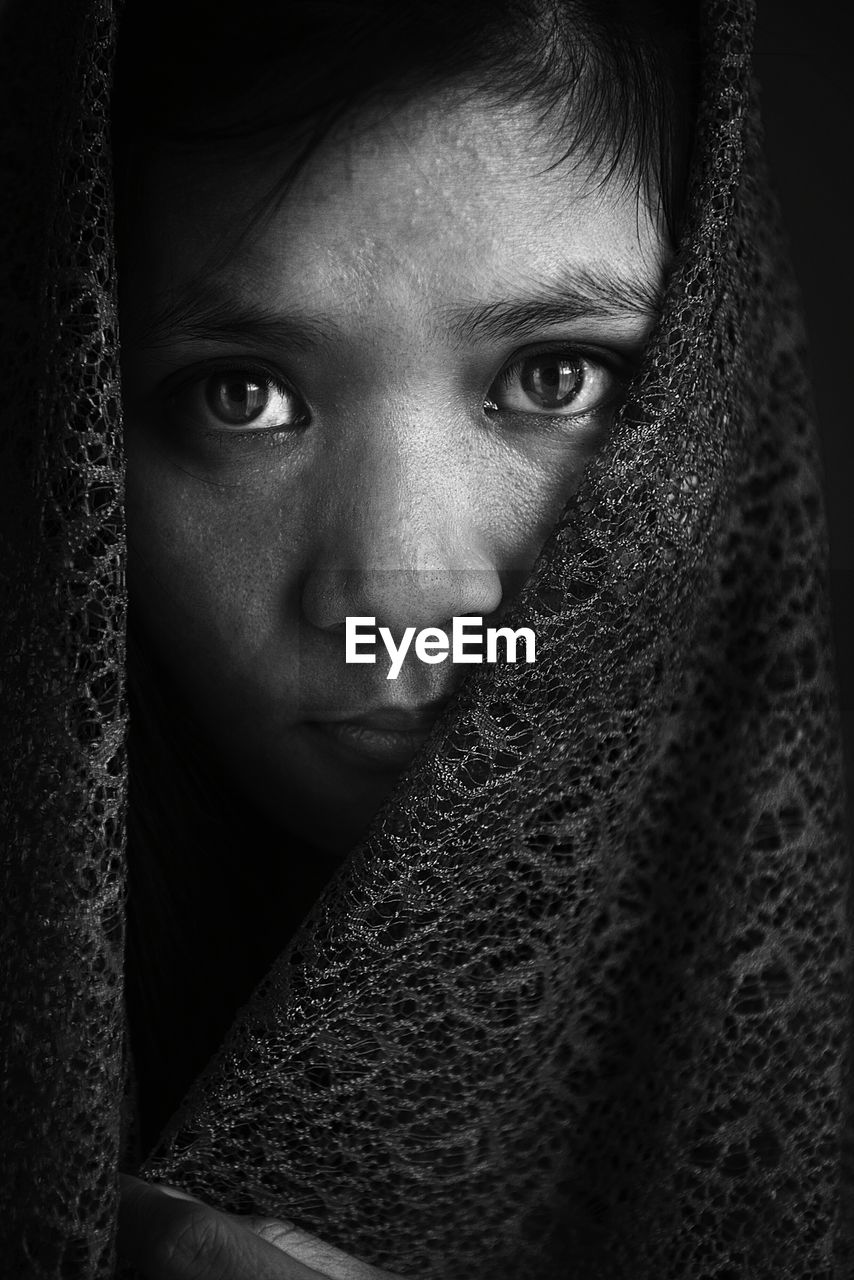 Close-up portrait of girl covered with shawl