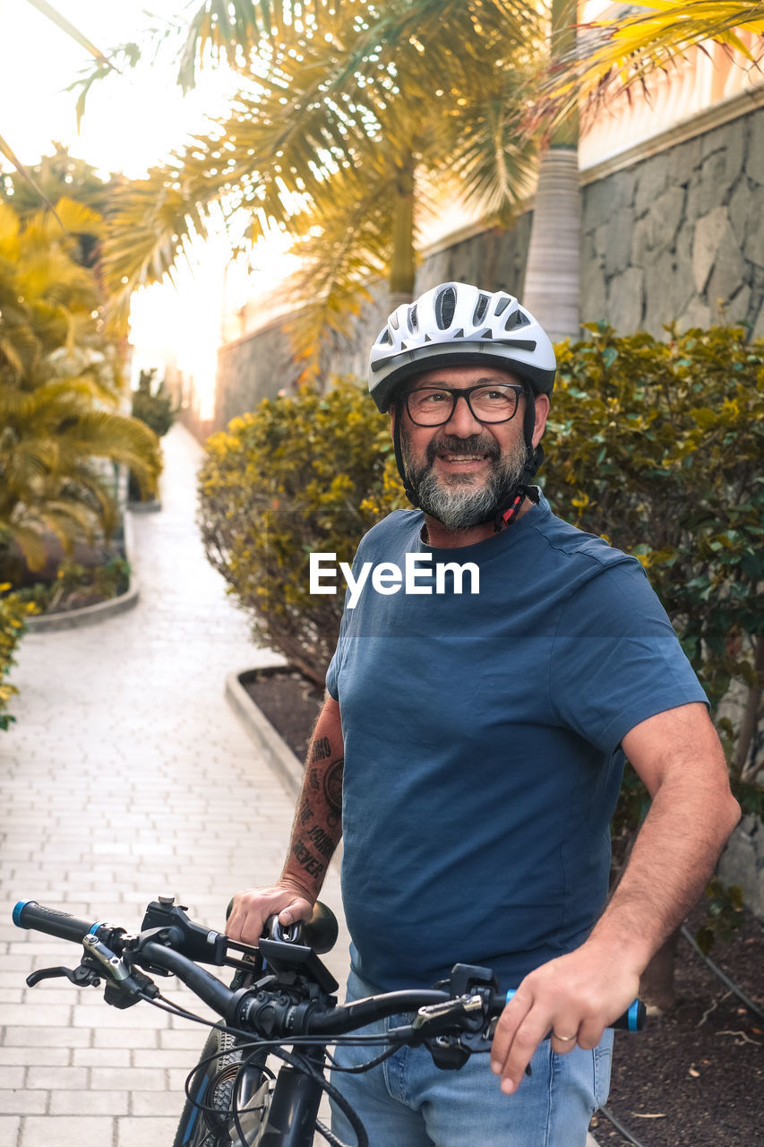 side view of man riding bicycle