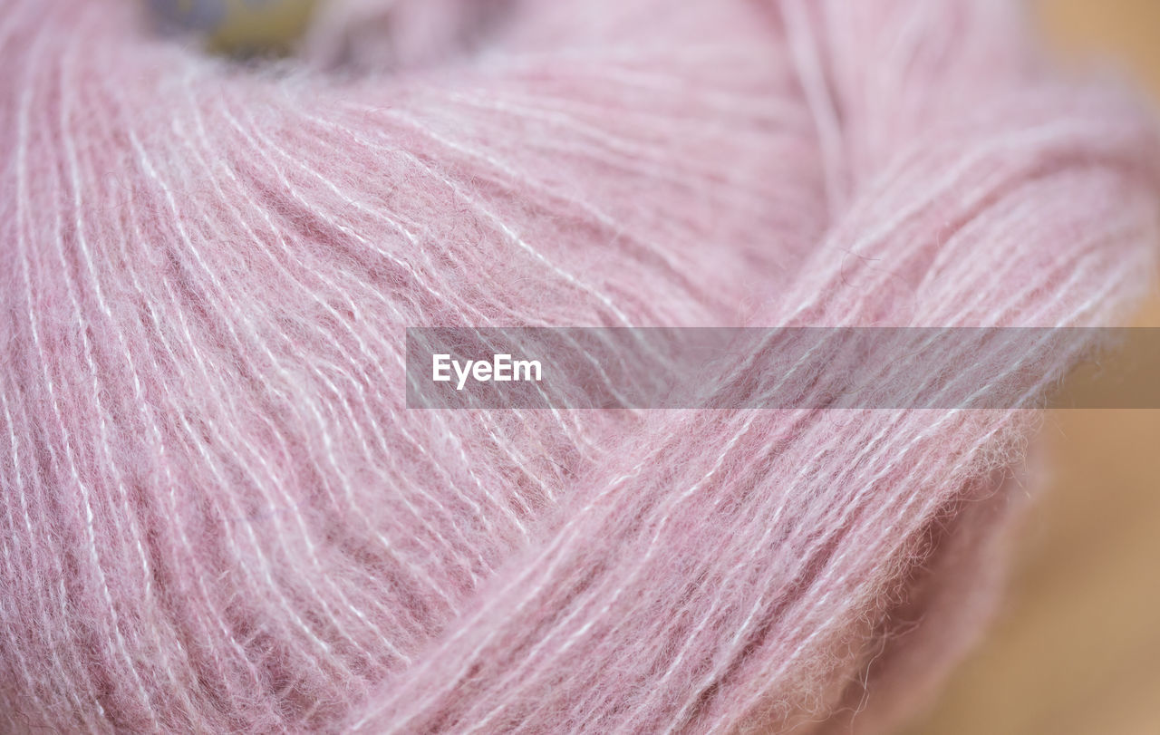 Close up of pink wool on table