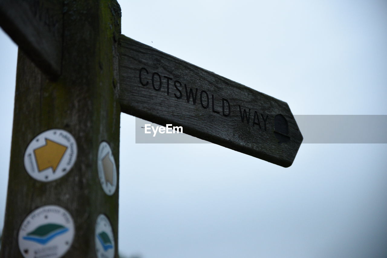 LOW ANGLE VIEW OF SIGN BOARD AGAINST SKY