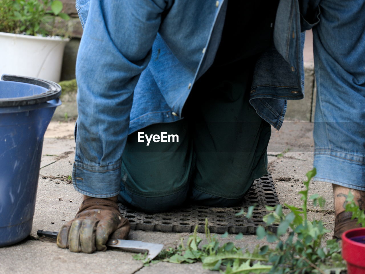 Midsection of man gardening in yard